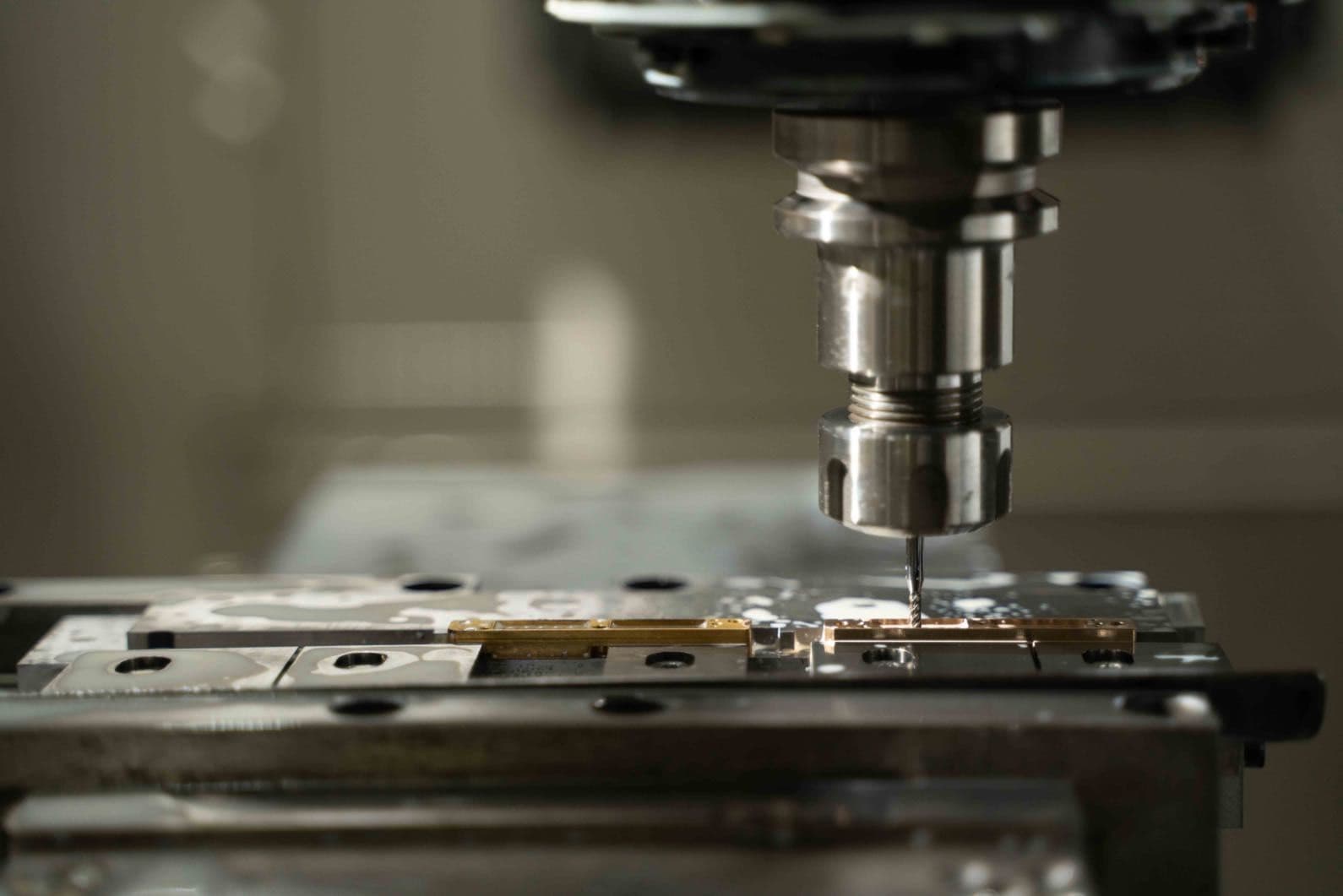 CNC milling machine cutting a precision tooling component at K-TOOL Engineering in Penang, Malaysia