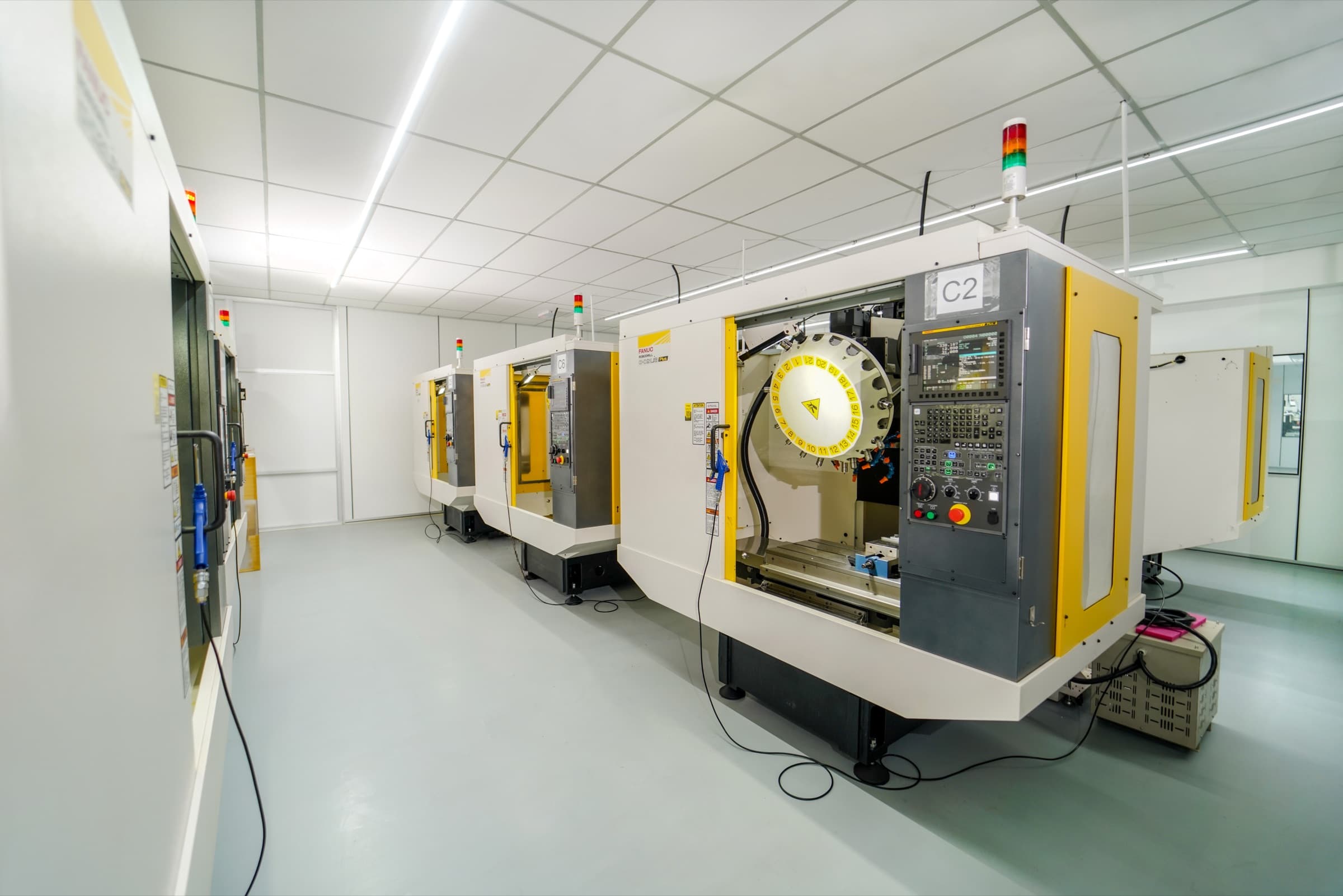 A row of FANUC Robodrill CNC milling machines with automatic tool changers in K-TOOL Engineering's CNC milling department in Penang, Malaysia